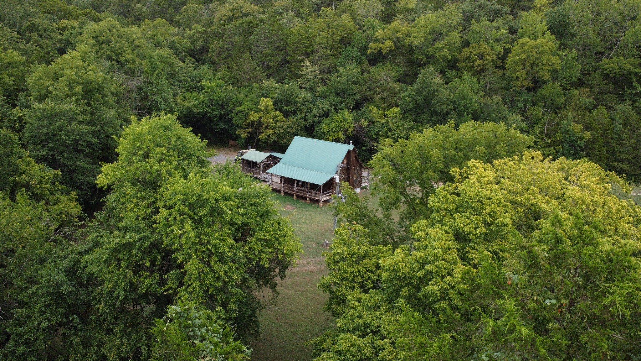 Drone view of Kindling Trail Cabin among dense trees